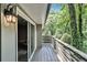 Spacious outdoor deck with wood flooring and surrounded by lush greenery, offering privacy at 6590 Williamson Ne Dr, Atlanta, GA 30328