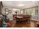 Traditional dining room featuring a large wooden table and seating for ten with natural lighting at 6590 Williamson Ne Dr, Atlanta, GA 30328