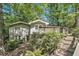 Home exterior with a wooden deck surrounded by greenery, creating a private and peaceful setting at 6590 Williamson Ne Dr, Atlanta, GA 30328