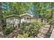 Charming home with a welcoming deck, surrounded by lush, mature trees at 6590 Williamson Ne Dr, Atlanta, GA 30328