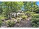 Two-story home with well-maintained stairs and landscaping, nestled amidst mature trees providing shade and privacy at 6590 Williamson Ne Dr, Atlanta, GA 30328