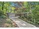 Front exterior showing the gray painted brick and lush landscaping surrounding the property at 6590 Williamson Ne Dr, Atlanta, GA 30328