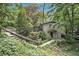 Charming two-story home nestled among mature trees and lush landscaping, featuring a stone walkway at 6590 Williamson Ne Dr, Atlanta, GA 30328