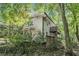 Two-story home showcasing a private balcony, fenced yard, and natural surroundings at 6590 Williamson Ne Dr, Atlanta, GA 30328