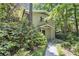 Charming house featuring stone pathway, lush landscaping and natural surroundings at 6590 Williamson Ne Dr, Atlanta, GA 30328