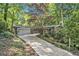Charming ranch home featuring a well-manicured lawn, mature trees, and an attached two-car garage at 6590 Williamson Ne Dr, Atlanta, GA 30328
