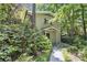 Charming two-story house featuring a quaint covered entryway and mature foliage, offering a private and inviting curb appeal at 6590 Williamson Ne Dr, Atlanta, GA 30328