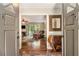 Inviting foyer with hardwood floors leading into the living area with a decorative wood console at 6590 Williamson Ne Dr, Atlanta, GA 30328