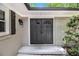 Elegant double front doors framed by decorative sidelights, enhancing curb appeal with a welcoming entrance at 6590 Williamson Ne Dr, Atlanta, GA 30328