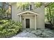 Inviting front entrance with a covered porch and a stylish door, enhanced by the surrounding greenery and stone pathway at 6590 Williamson Ne Dr, Atlanta, GA 30328