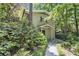 Charming two-story home with brick facade and inviting front entrance surrounded by lush landscaping at 6590 Williamson Ne Dr, Atlanta, GA 30328