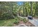 Landscaped front yard with a mailbox bearing the house number, mature trees and lawn at 6590 Williamson Ne Dr, Atlanta, GA 30328