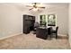 Cozy home office with desk, shelving, and bright natural light from nearby windows at 6590 Williamson Ne Dr, Atlanta, GA 30328