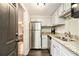 Bright kitchen with stainless steel appliances, granite countertops, and white cabinets at 6590 Williamson Ne Dr, Atlanta, GA 30328