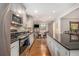 Well-lit kitchen with stainless steel appliances, granite countertops, and eat-in breakfast area at 6590 Williamson Ne Dr, Atlanta, GA 30328