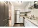 Updated kitchen with white cabinets, granite countertops, and stainless steel appliances at 6590 Williamson Ne Dr, Atlanta, GA 30328
