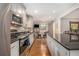 Open concept kitchen featuring stainless steel appliances, granite counters, and a view of the eat-in area at 6590 Williamson Ne Dr, Atlanta, GA 30328