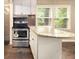 Bright kitchen with granite countertops, white cabinets, and stainless steel appliances at 6590 Williamson Ne Dr, Atlanta, GA 30328