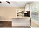 Open concept kitchen featuring white cabinetry, granite countertops, and a view into the living area at 6590 Williamson Ne Dr, Atlanta, GA 30328