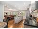 Spacious eat-in kitchen featuring stainless steel appliances, granite counters, and views to the dining room at 6590 Williamson Ne Dr, Atlanta, GA 30328