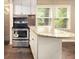 Kitchen island with seating, stainless steel appliances, granite countertops, and natural light at 6590 Williamson Ne Dr, Atlanta, GA 30328