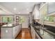 Spacious kitchen featuring stainless steel appliances, granite counters, and a peninsula with views to the dining room at 6590 Williamson Ne Dr, Atlanta, GA 30328