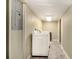Laundry area featuring a washer and dryer along a narrow hallway at 6590 Williamson Ne Dr, Atlanta, GA 30328