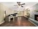 Open living room with hardwood floors, brick fireplace, and views into the kitchen at 6590 Williamson Ne Dr, Atlanta, GA 30328