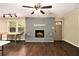 Living room featuring a fireplace with a light gray brick surround and finished hardwood floors at 6590 Williamson Ne Dr, Atlanta, GA 30328