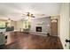 Spacious living room featuring a fireplace with a light gray brick surround and finished hardwood floors at 6590 Williamson Ne Dr, Atlanta, GA 30328