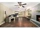 Spacious living room featuring a fireplace with a light gray brick surround and an adjacent open kitchen at 6590 Williamson Ne Dr, Atlanta, GA 30328