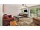 Comfortable living room featuring a ceiling fan, hardwood floors, and sliding glass doors to the deck at 6590 Williamson Ne Dr, Atlanta, GA 30328