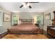 Relaxing main bedroom features hardwood floors, a ceiling fan and tranquil nature views at 6590 Williamson Ne Dr, Atlanta, GA 30328