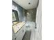 Updated bathroom with granite countertops, glass shower door, and tiled floors at 6832 Shangrila Way, Riverdale, GA 30296