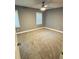Spacious bedroom with neutral carpet, two windows, and a ceiling fan at 6832 Shangrila Way, Riverdale, GA 30296