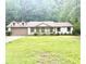 Charming single-story home with a well-maintained lawn and an attached two-car garage at 6832 Shangrila Way, Riverdale, GA 30296