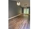 Bright open-concept living space with modern lighting and wood flooring at 6832 Shangrila Way, Riverdale, GA 30296