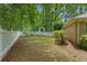 Lush backyard features a white picket fence and an archway creating a peaceful outdoor retreat at 11190 Hembree Springs Dr, Roswell, GA 30076