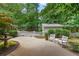 Backyard features a well-maintained patio area with white chairs, landscaping, and a white picket fence for a relaxing outdoor space at 11190 Hembree Springs Dr, Roswell, GA 30076
