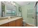 Bathroom featuring a vanity with granite countertops, tile flooring and a glass shower at 11190 Hembree Springs Dr, Roswell, GA 30076