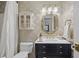 Elegant bathroom featuring a decorative mirror, cabinet vanity and shower with gold accents at 11190 Hembree Springs Dr, Roswell, GA 30076