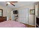Bedroom with hardwood floors, ceiling fan and closet at 11190 Hembree Springs Dr, Roswell, GA 30076
