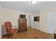 This bedroom features hardwood floors, classic wood furnishings and a light fixture at 11190 Hembree Springs Dr, Roswell, GA 30076