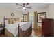 Well-lit bedroom with hardwood floors and a decorative wrought-iron bed at 11190 Hembree Springs Dr, Roswell, GA 30076