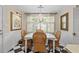 Dining area with a chandelier, dining table with wicker chairs, and black and white tile flooring at 11190 Hembree Springs Dr, Roswell, GA 30076
