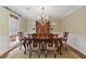 Elegant dining room with ornate chandelier and classic wooden dining set at 11190 Hembree Springs Dr, Roswell, GA 30076