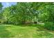 This home sits on a sprawling lot with mature trees, providing ample shade and privacy at 11190 Hembree Springs Dr, Roswell, GA 30076
