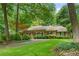 Beautiful home nestled among mature trees with a well-manicured lawn at 11190 Hembree Springs Dr, Roswell, GA 30076