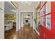 Foyer featuring wood floors, a chandelier, a large mirror and a red front door at 11190 Hembree Springs Dr, Roswell, GA 30076
