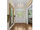 Foyer features wood floors, a chandelier, and a large mirror with an arched doorway, and transom window at 11190 Hembree Springs Dr, Roswell, GA 30076